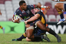 Samu Kerevi of the Reds is tackled by David Pocock of the Brumbies during the Super Rugby Pre-Season match 