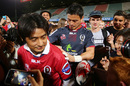 Ayumu Goromaru of the Reds poses with fans and signs autographs after the Super Rugby Pre-Season match between the Reds and the Brumbies