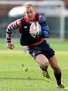 Mike Brown runs with the ball during an England training session