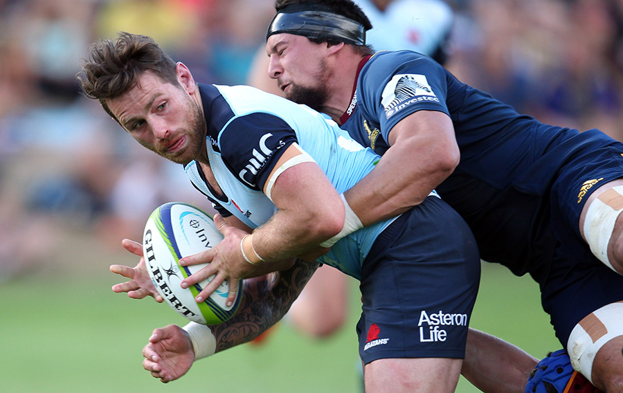 Bernard Foley of the Waratahs looks to off-load the ball during the Super Rugby trial match