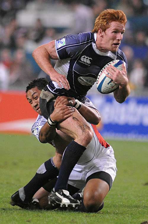 Roddy Grant of Scotland is tackled