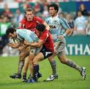 Pablo Gomez Cora of Argentina is tackled by the Hong Kong defence