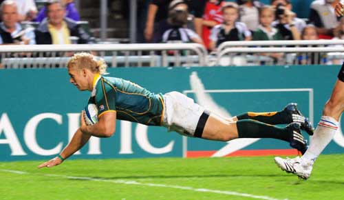 Kyle Brown of South Africa dives in to score