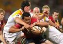 The Reds' Digby Ioane is tackled by the Chiefs' defence