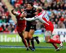 The Ospreys' James Hook is tackled by Gloucester's Andy Hazell and Mike Tindall