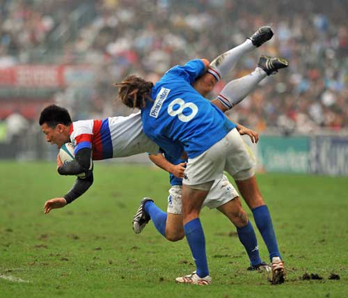 South Korea's Kim Wong-Yong is tackled by Uruguay's Santiago Gibernau