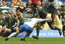 South Africa's Mzwandile Stick is tackled by Uruguay's Andres Lussich