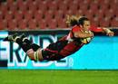 The Lions' Todd Clever dives over to score a try