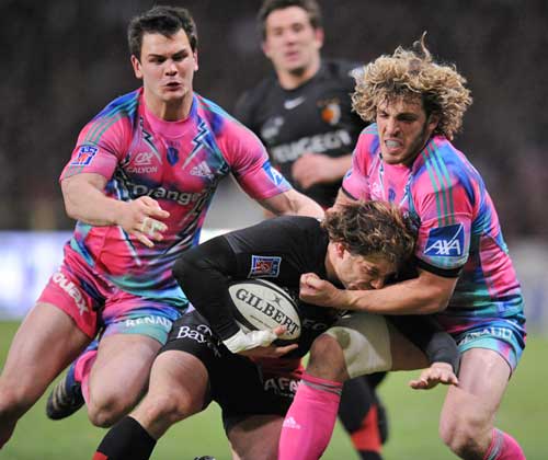Toulouse's Cedric Heymans is tackled by Stade Francais' Micro Bergamasco