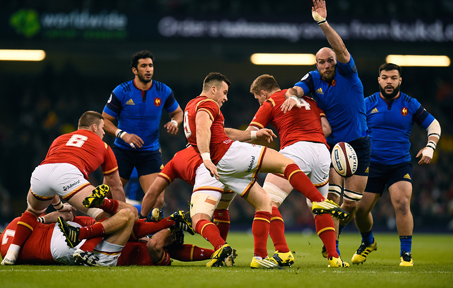 Wales scrum-half Gareth Davies clears upfield despite pressure from the French pack