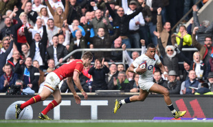 England's wing Anthony Watson (R) runs past Wales' full back Liam Williams (L) to score England's first try during the Six Nations international rugby union match between England and Wales at Twickenham in south west London on March 12, 2016.   / AFP / BEN STANSALL        (Photo credit should read BEN STANSALL/AFP/Getty Images)