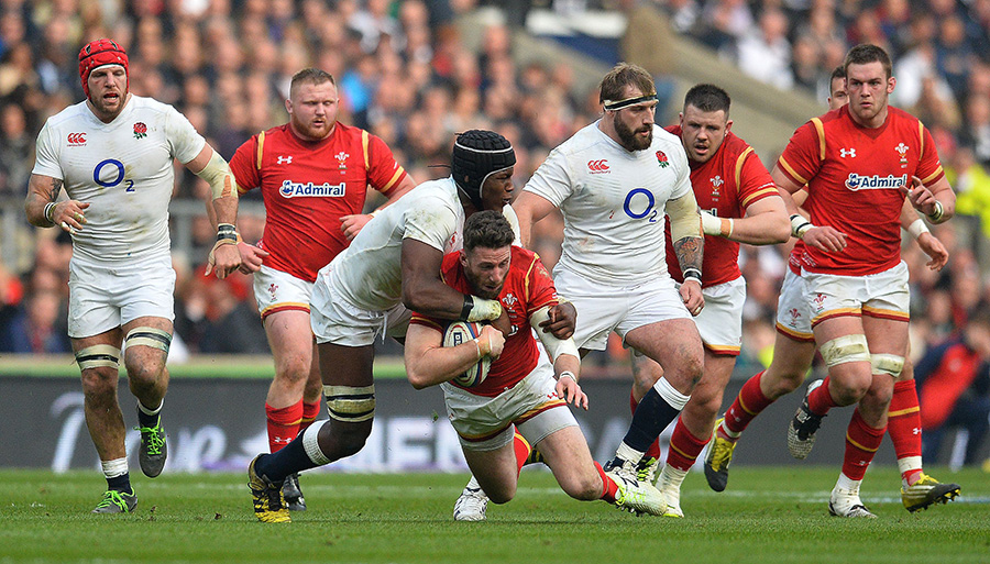 Wales' wing Alex Cuthbert is tackled by England's lock Maro Itoje 