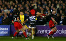 Alex Goode of Saracens is tackled in the air by Anthony Watson of Bath