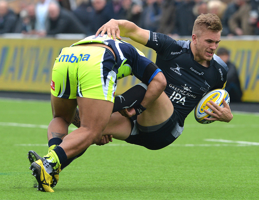 Chris Harris of Newcastle Falcons is tackled by TJ Loane of Sale Sharks