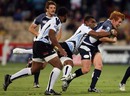 Roddy Grant of Scotland is wrapped up the Fiji defence during day one of the IRB Adelaide International Rugby Sevens match between Fiji and Scotland
