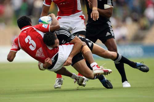 Sosaia Palei of Tonga is tackled by Zar Lawrence of New Zealand 