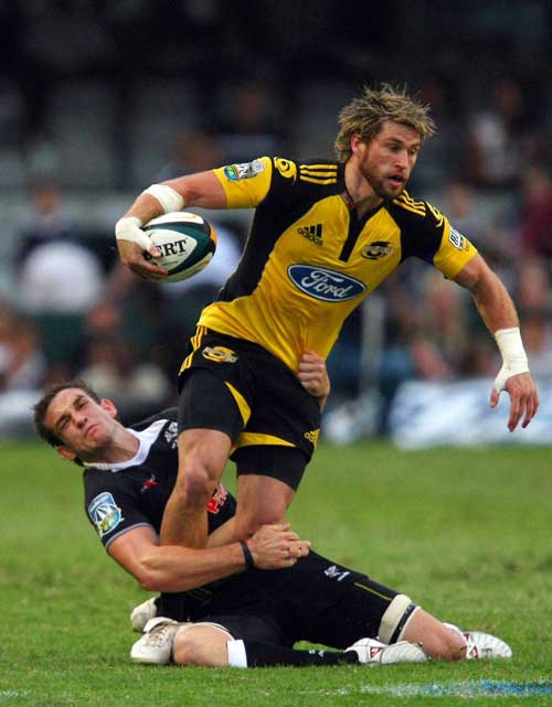 Hurricanes fullback Cory Jane is caught by the Sharks defence
