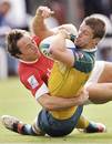 Shaun Foley of Australia is tackled by Will Harries of Wales
