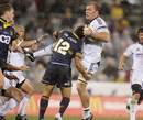 The Brumbies' Tyrone Smith tackles the Stormers' Schalk Burger