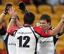 The Lions' Doppies Le Grange, Earl Rose and Jannie Boshoff celebrate victory over the Reds
