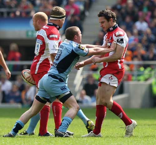 Cardiff Blues scrum-half Richie Rees reacts to an off-the-ball tackle from Gloucester's Ryan Lamb