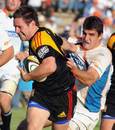 The Chiefs' Mike Delany is tackled by the Cheetahs' Hennie Daniller
