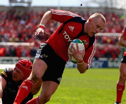 Munster's Keith Earls evades the tackle of the Ospreys' Alun Wyn-Jones