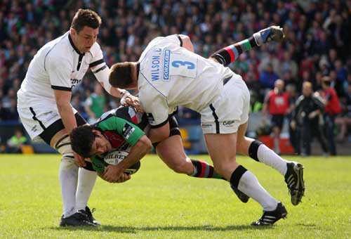 Harlequins' Gonzalo Tiesi is tackled by Newcastle's David Wilson