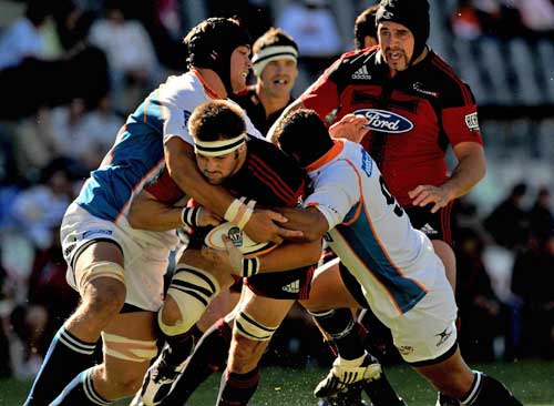 The Crusaders' Richie McCaw is shackled by the Cheetahs' defence