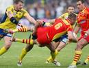 Perpignan's Gregory Lecorvec is tackled by Clermont's Gonzalo Canale