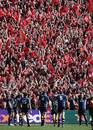 Leinster's players walk back behind the posts as Munster's fan's celebrate