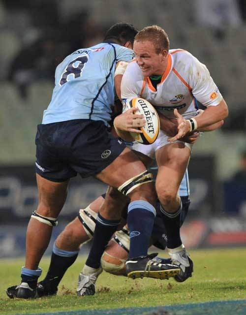 The Cheetahs' Meyer Bosman is tackled by the Waratahs' Wycliff Palu
