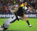 The Chiefs' Mils Muliaina is tackled by the Hurricanes' Ma'a Nonu
