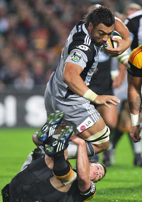 The Hurricanes' Victor Vito is tackled by the Chiefs' defence