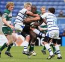 Leicester's Ayoola Erinle is wrapped up by the Bath defence