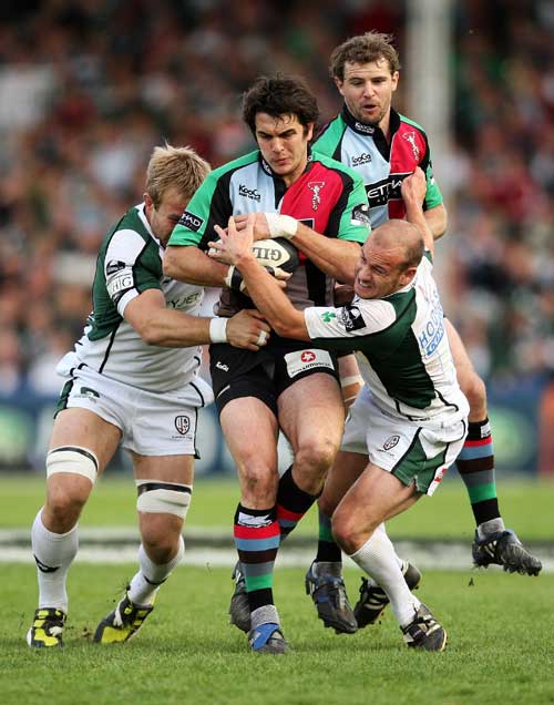 Harlequins' Gonzalo Tiesi is wrapped up by the London Irish defence