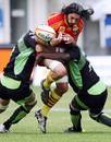 Perpignan flanker Jean-Pierre Perez is tackled by the Montauban defence