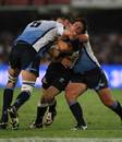 Sharks scrum-half Rory Kockott is tackled by Victor Matfield