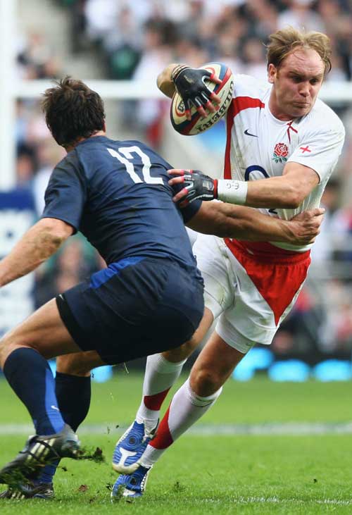England fly-half Andy Goode breaks past Yannick Jauzion of France