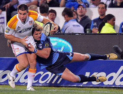 Chiefs wing Dwayne Sweeney is tackled by Wynand Olivier