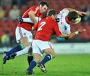 The Golden Lions' Willem Alberts is tackled by the Lions' Stephen Jones and Lee Mears