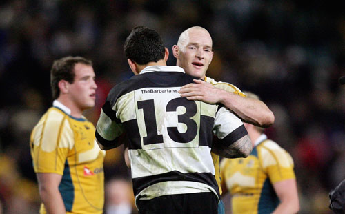 Australia's captain Stirling Mortlock embraces the Barbarian's Sonny Bill Williams after the game