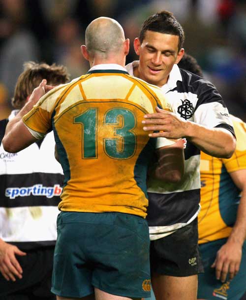 Barbarians centre Sonny Bill Williams embraces the Wallabies' Stirling Mortlock