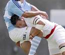 Argentina Jaguars' Horacio Alberto San Martin is tackled by the England Saxons' Phil Dowson