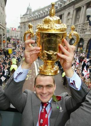 Trevor Woodman holds the Rugby World Cup during the England victory parade, London, Englands, December 8, 2003