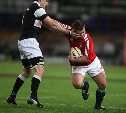 British & Irish Lions hooker Lee Mears is tackled by the Sharks' Keegan Daniels