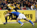 Australia's Adam Ashley-Cooper is tackled by Craig Gower of Italy