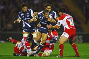 Rory Lamont of Sale is tackled by Alasdair Dickinson, Olivier Azam (R) and Marco Bortolami of Gloucester during the Guinness Premiership match between Sale and Gloucester at Edgeley Park on September 26, 2008 in Stockport, England. 