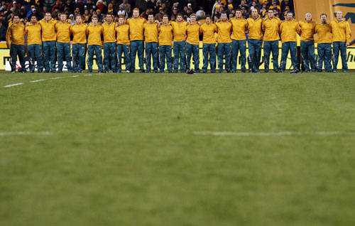 The Australian players sing the national anthem before the First Test against Italy