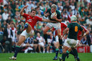 Lions' centre Jamie Roberts is beaten to the ball by Jean De Villiers